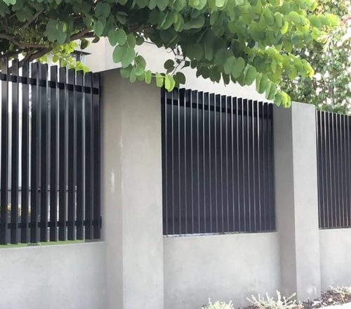 black aluminium slat fencing between brick pillars
